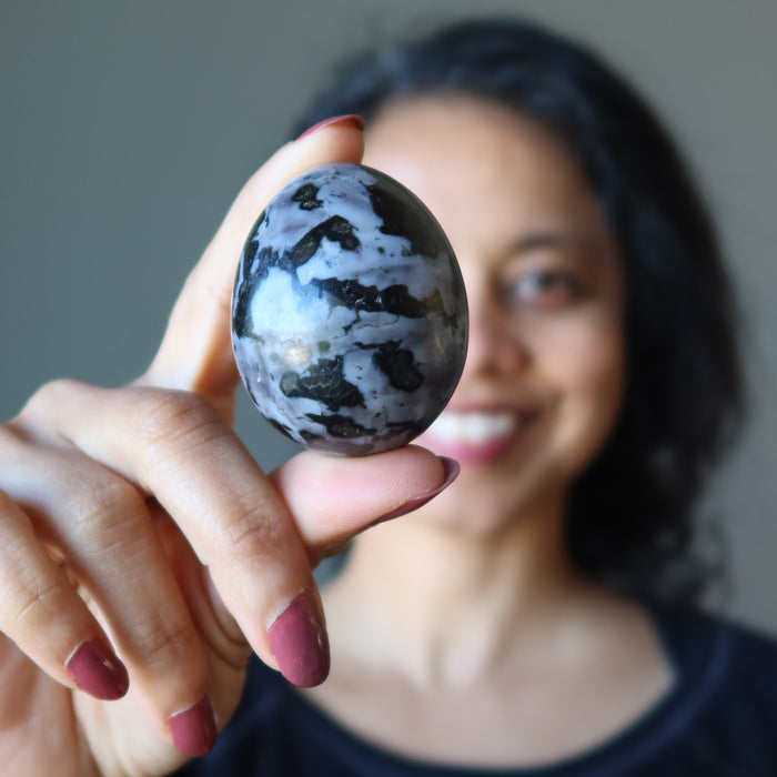 sheila of satin crystals holding Gabbro Egg in front