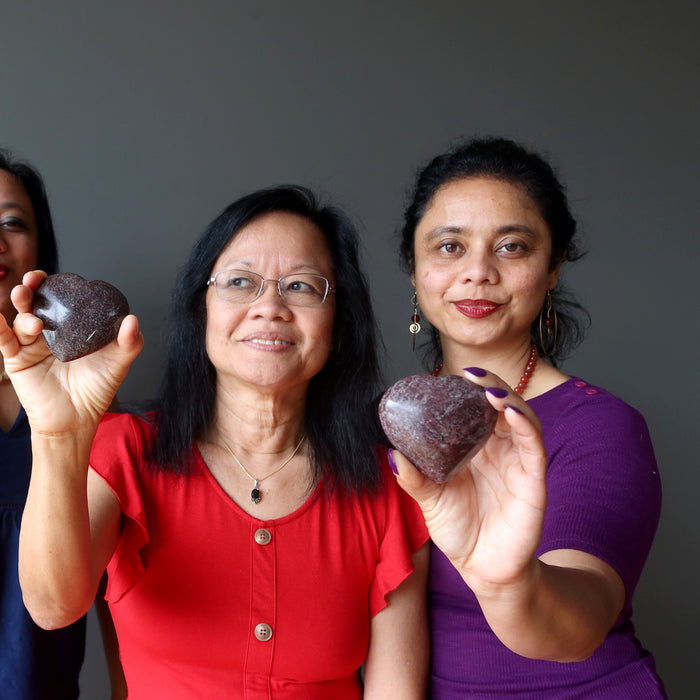 mother and daughter holding garnet hearts