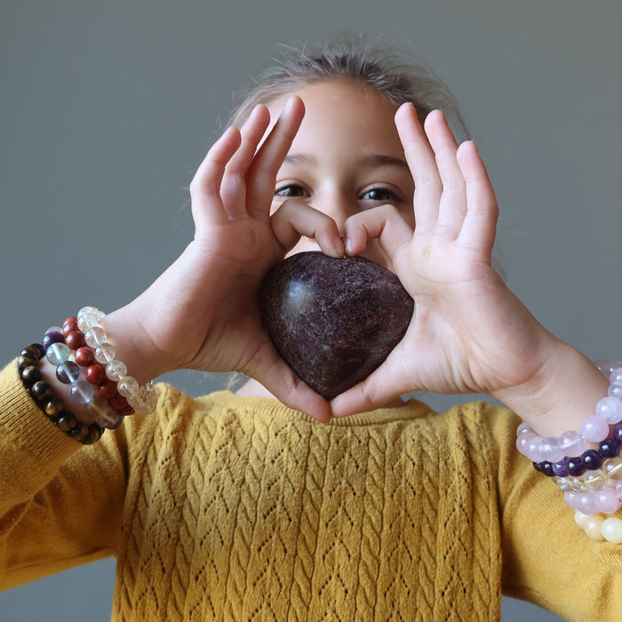 girl holding a garnet heart