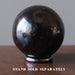 red garnet sphere on hematine ring stand which is sold separately