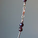 zooming garnet necklace showing the lobster clasp