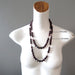 two differnt size garnet necklaces on mannequin
