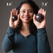 sheila of satin crystals holding two garnet balls to show difference in size