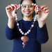 sheila of satin crystals holding Goldstone Necklace 