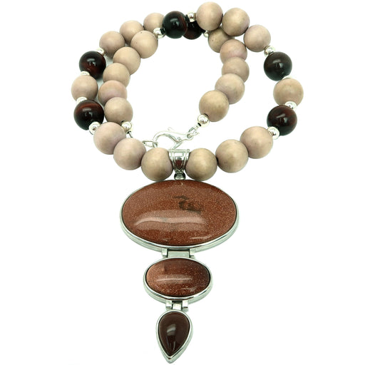 Goldstone pendant hanging from beaded brown Goldstone brown Wood and  Red Tigers Eye necklace set in a silver secured with a silver-plated lobster claw clasp.