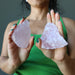 sheila of satin crystals holding pair of rough pink rose quartz stones
