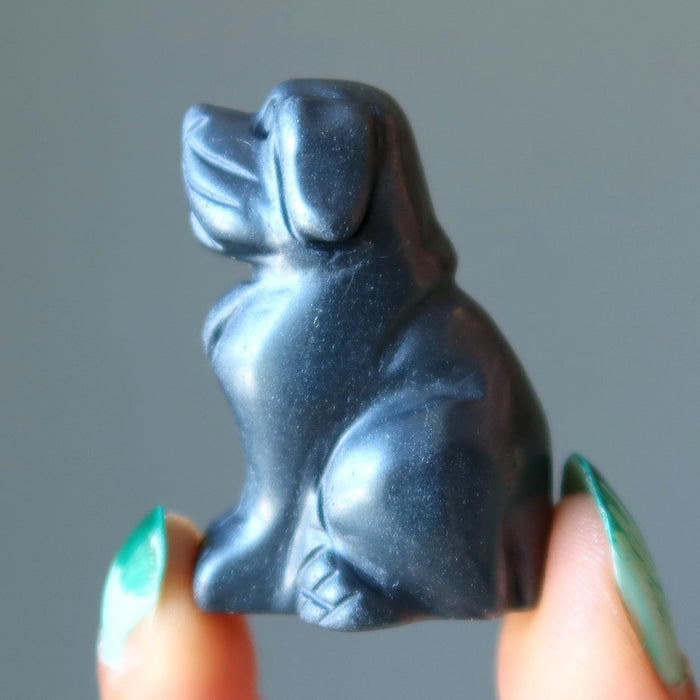 finger tips holding Hematite Dog