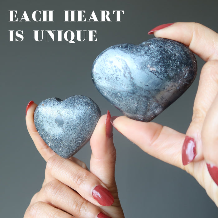 hands holding hematite hearts
