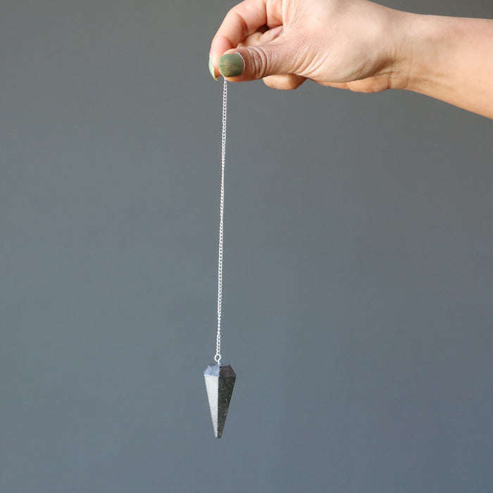 hematite pendulum in hand