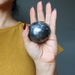 hematite sphere in palm of hand