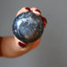 hand holding hematite sphere