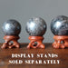 three hematite spheres on wood ball stands, which are sold separately
