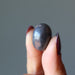 finger tips holding Hematite Tumbled Stone