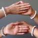 four hands all wearing howlite stretch bracelets