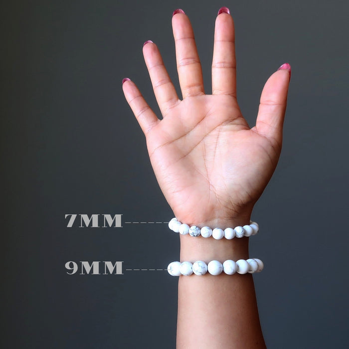 hand wearing howlite bracelets in 7mm and 9mm
