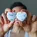 sheila of satin crystals holding two Howlite Hearts