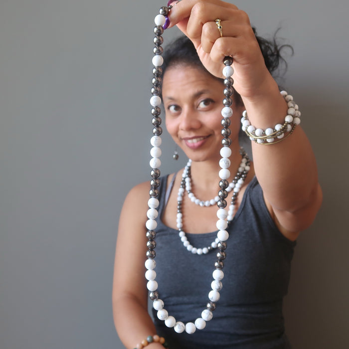sheila of satin crystals wearing howlite necklace and holding in front another Howlite Necklace