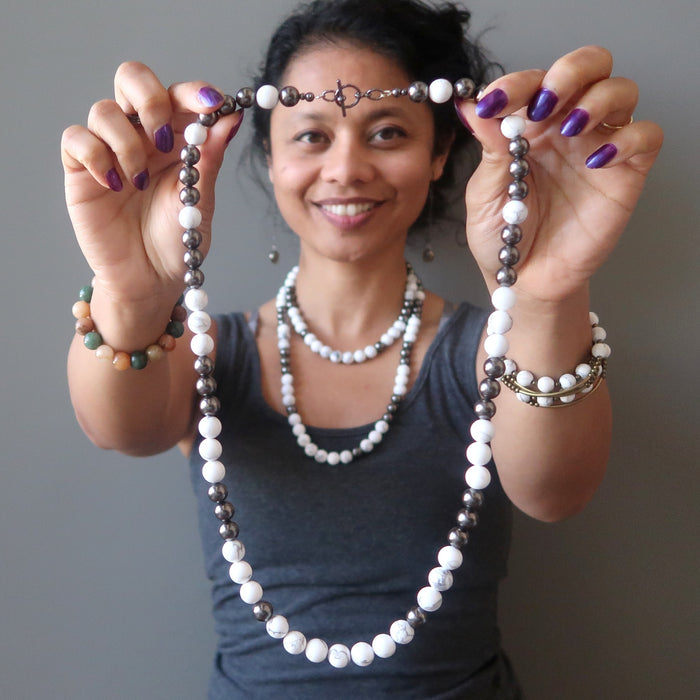 sheila of satin crystals wearing howlite necklace and holding in front another Howlite Necklace
