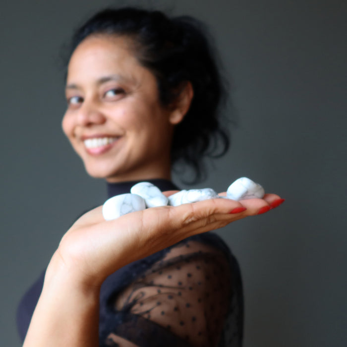 sheila of satin crystals holding white and gray howlite tumbled stones