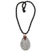 freeform Howlite slab necklace wrapped in copper wire with a black and gray Snowflake Obsidian donut amulet pendant hangs from a satin-finished nylon twist necklace secured with a knot clasp.