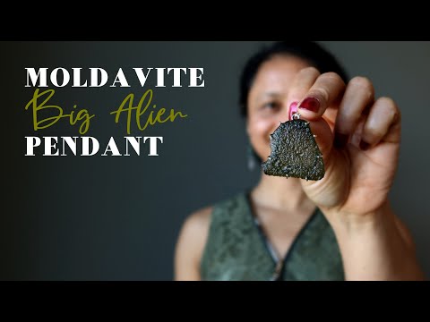 video featuring large raw moldavite in sterling silver pendant