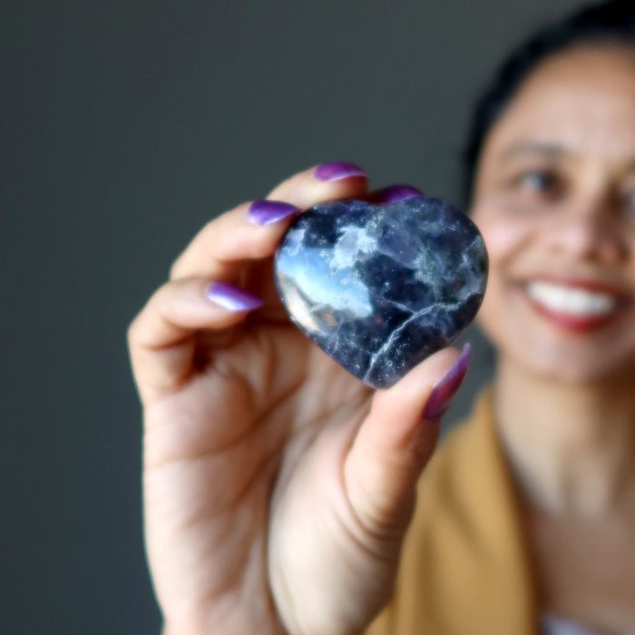 woman holding iolite heart
