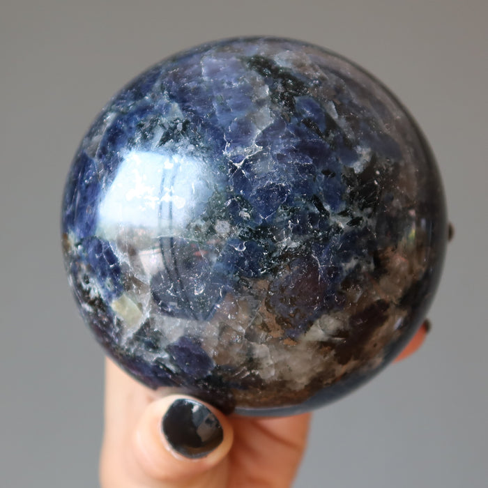 hand holding iolite sphere