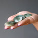 hand holding five jade amulets