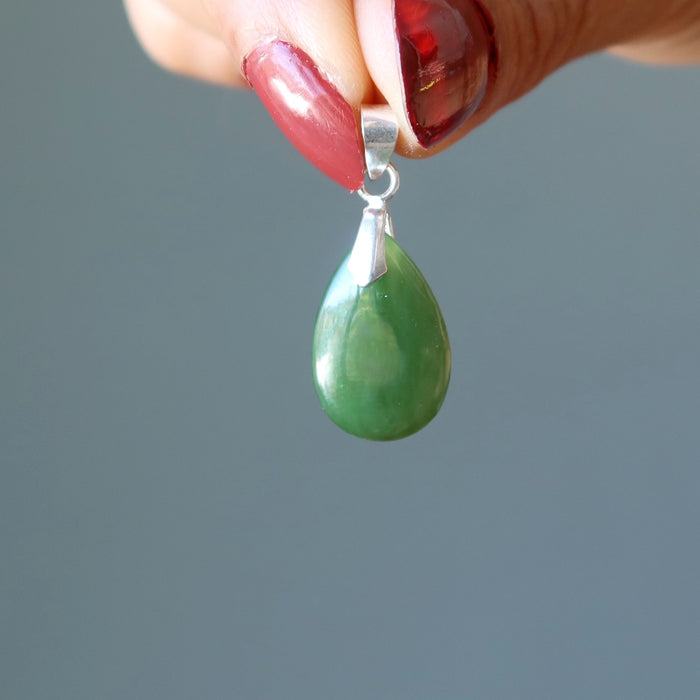 hand holding jade pendant