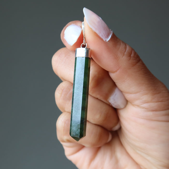 hand holding jade faceted point pendant