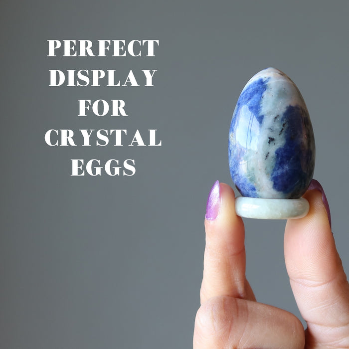 hand holding jade ring used to display blue sodalite egg