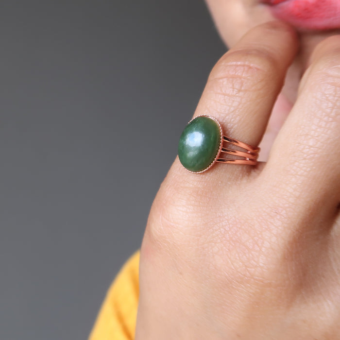 hand on chin wearing green jade oval in copper adjustable ring