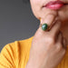 hand on chin wearing nephrite jade oval in gold adjustable ring