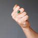 hand making a fist wearing nephrite jade oval in gold adjustable ring