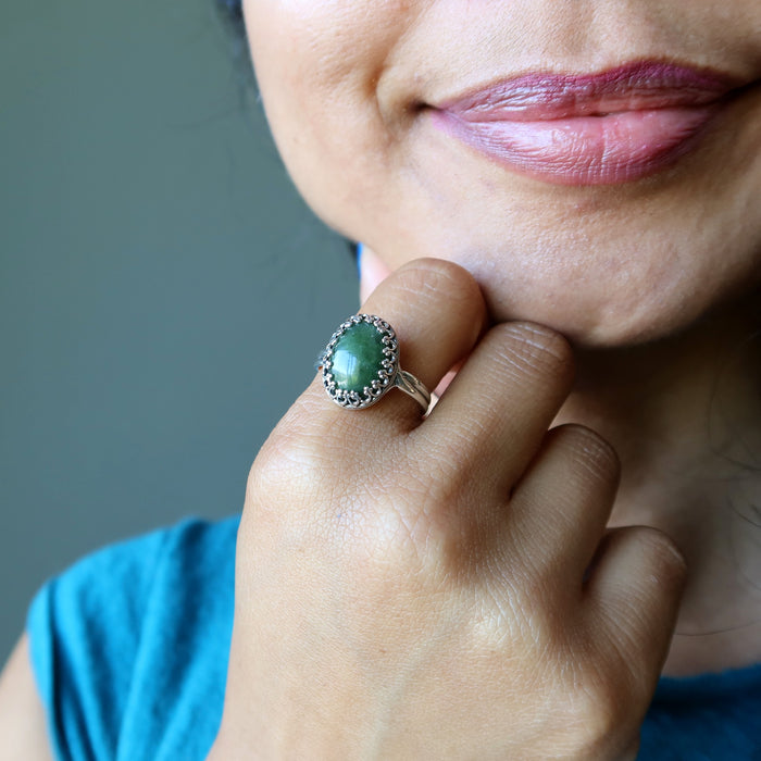 nephrite jade oval in sterling silver ring on hand on chin