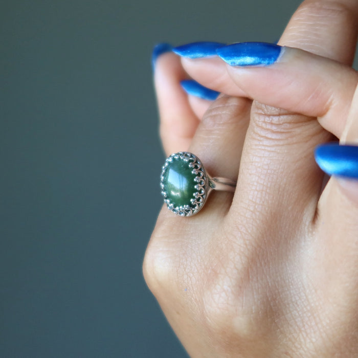 hand wearing nephrite jade oval in sterling silver ring