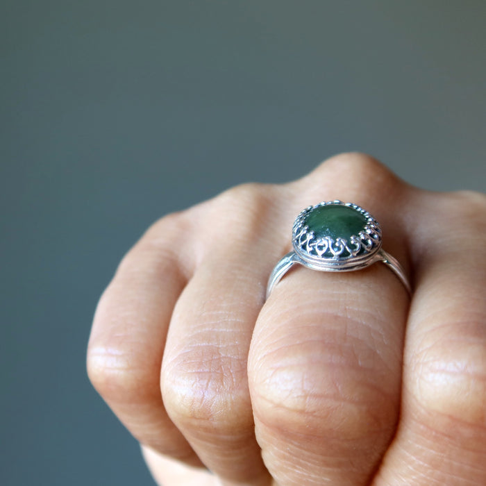 finger wearing nephrite jade oval in sterling silver ring