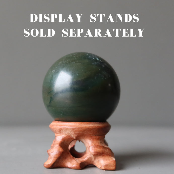 dark green jade sphere on wood stand