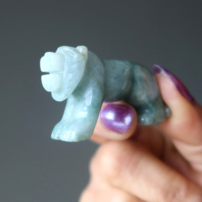 hand holding green jade tiger carving