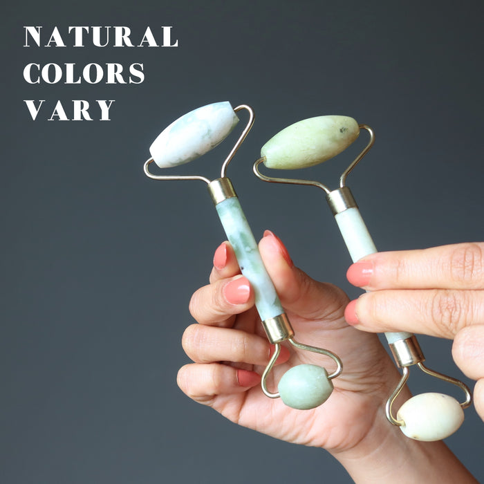 hand holding two jade rollers to show natural colors vary