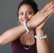 sheila of satin crystals wearing white jade round beaded stretch bracelet on each wrist