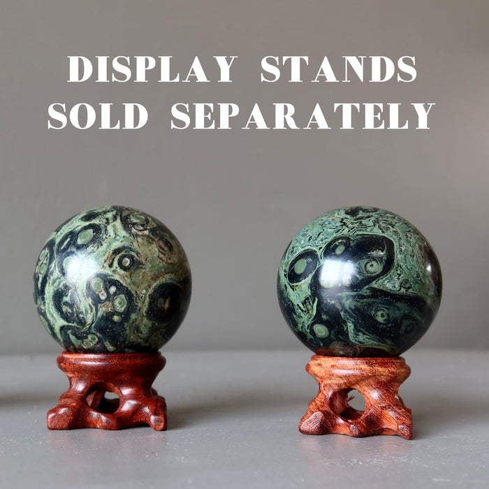two green kambaba jasper spheres on display stands whcih are sold separately