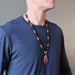 male wearing mookaite jasper and red garnet beaded necklace