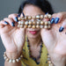 sheila of satin crystals holding three landscape jasper bracelets in front of her face