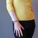 woman with hand at hip modeling a faceted brown landscape jasper bracelet