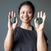 sheila of satin crystals holding set of kambaba jasper polished stones in each palm