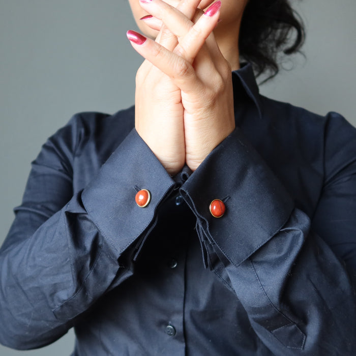 hands clasped wearing red jasper cufflinks on black french cuff shirt