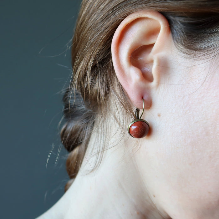 holly of satin crystals wearing red jasper in antique bronze leverback earrings