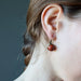 holly of satin crystals wearing red jasper in antique bronze leverback earrings