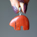 hand holding red jasper bear pendant